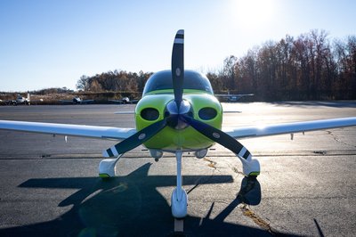 Lime green and white Cirrus SR-series aircraft detail, image N294GG-029.