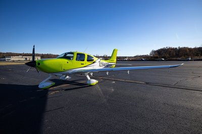 Lime green and white Cirrus SR-series aircraft detail, image N294GG-030.