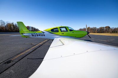 Lime green and white Cirrus SR-series aircraft detail, image N294GG-046.