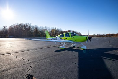Lime green and white Cirrus SR-series aircraft detail, image N294GG-047.