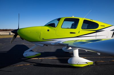Lime green and white Cirrus SR-series aircraft detail, image N294GG-050.