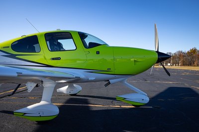 Lime green and white Cirrus SR-series aircraft detail, image N294GG-060.